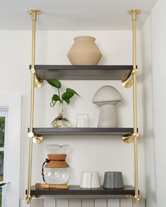 three shelves with vases and other items on them