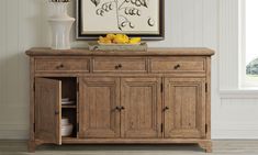 a large wooden cabinet with drawers underneath a painting