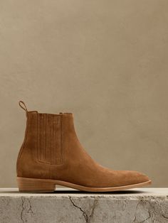 We stripped down the classic Western boot to focus on a streamlined silhouette that really shows off this rich, Italian suede.  Plus, we added a small surprise if you look closely: the toe of the boot is a rounded, almond shape, set to contrast with a squared toe created by its Italian leather soles for sculptural effect.  Leather uppers, lining and soles.  Foam footbed for comfort.  Made in Portugal.  Whole and half sizes. Fitted Boots With Suede Lining And Almond Toe, Fitted Suede Boots With Round Toe, Classic Chelsea Boots With Suede Lining For Fall, Modern Fitted Chelsea Boots With Round Toe, Fitted Modern Chelsea Boots With Round Toe, Formal Fitted Suede Chelsea Boots, Chelsea Boots With Reinforced Heel And Almond Toe, Fitted Chelsea Boots With Reinforced Almond Toe, Fitted Chelsea Boots With Reinforced Heel And Almond Toe