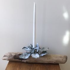 a candle that is on top of a piece of wood