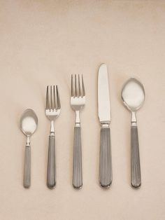 five silverware with spoons and two forks