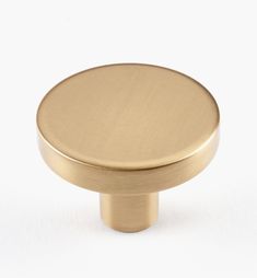 an image of a brass knob on a white background for use as a cabinet door handle