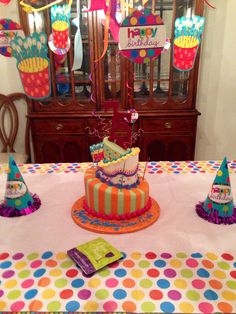 a birthday cake on a table with party decorations