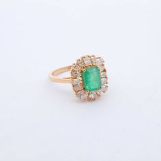 Indulge in luxury with our exquisite Emerald and Diamond Cocktail Ring. Adorned with stunning emeralds and diamonds, this ring exudes sophistication and elegance. Elevate any outfit with this timeless piece, perfect for any occasion. Feel like a true icon when you wear our Emerald & Diamond Cocktail Ring. 14k Yellow Gold 1.75CTW Natural Emerald Natural Diamonds: .80CTW Round Diamonds Luxury Emerald Ring With 17 Jewels For Promise, Luxury Green Emerald Ring With Rose Cut Diamonds, Timeless Emerald Ring With Diamond Accents For Wedding, Elegant 14k Gold Emerald Ring For Formal Occasions, Elegant 14k Gold Emerald Ring With Center Stone, Green Emerald Cut Diamond Ring With Rose Cut Diamonds, Timeless Emerald Wedding Ring For May Birthstone, Luxury Yellow Gold Cluster Emerald Ring, Luxury Cluster Emerald Ring In Yellow Gold