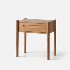 a small wooden table with one drawer open