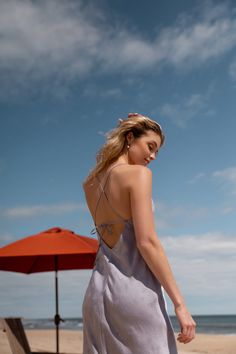 The Jenny Yoo Leilani slip dress is a chic and modern update to the classic slip dress. Featuring a V neck and a delicate spaghetti strap to highlight your shoulders and collarbone. The low scoop back has a barely there feeling, and the bias cut skirt slinks over every curve. A dainty tie at the back adds one last flirtatious detail. Available in Clay Rosette Pink and Oxford Blue. Ready to ship. Shop online now! Spring Dress With Built-in Bra And Strappy Back, V-neck Slip Dress With Delicate Straps, Chic V-neck Slip Dress With Tie Straps, V-neck Sundress With Delicate Straps For Brunch, Elegant Slip Dress With Built-in Bra And Strappy Back, Beach Slip Dress With Spaghetti Straps And Built-in Bra, Backless Fitted Midi Dress With Delicate Straps, Spring Low Back Backless Dress With Tie Back, Feminine V-neck Slip Dress With Delicate Straps