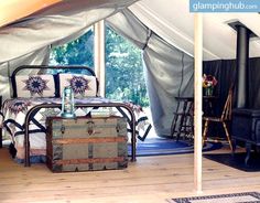 the inside of a tent with furniture and decor