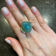 This Sky Blue Cabochon Ring Exudes Elegance With Its Stunning, Iridescent Blue Stone. A Timeless Piece, It Can Be Worn For Any Occasion, Adding A Touch Of Sophistication To Any Outfit. Enhance Your Style With This Beautiful And Versatile Ring. Ring Size 7 Made Of: Sky Blue Agate Silver Plating (7-10 Microns) Over Brass Made In Brazil Disclaimer: Please Note That All Semiprecious Stones Have Imperfections And Are Part Of Their Own Beauty. Due To Changes In Lighting, A Product May Appear Different Blue Fusion Style Round Rings, Elegant Nickel Free Opal Ring, Nickel Free Elegant Opal Ring, Blue Opal Ring With Natural Stones, Modern Blue Moonstone Gemstone Ring, Unique Blue Moonstone Ring With Natural Stones, Blue Moonstone Ring In Sterling Silver For Formal Occasions, Modern Blue Moonstone Ring, Elegant Blue Ring With Natural Stones