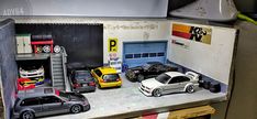 several toy cars are parked in a garage