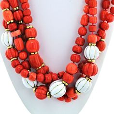 This exquisite 18K Yellow Gold Coral and White Enamel Multi-Strand Necklace by David Webb is a true masterpiece that captures the essence of elegance and timeless beauty. Crafted with utmost precision and attention to detail, this necklace tells a story of sophistication and luxury.The necklace features four strands of natural carved coral and white enamel beads, meticulously arranged to create a stunning visual display. The combination of the vibrant coral and the pristine white enamel beads ev Elegant Orange Polished Beads Jewelry, Elegant Orange Jewelry With Polished Beads, Elegant Orange Necklaces With Polished Beads, Classic Orange Necklace For Formal Occasions, Classic Orange Necklaces For Formal Occasions, Orange Classic Formal Necklaces, Orange Classic Formal Necklace, Luxury White Necklace With Polished Beads, Luxury White Necklaces With Polished Beads