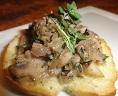 a piece of bread topped with mushrooms and herbs