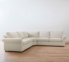 a white couch sitting on top of a hard wood floor