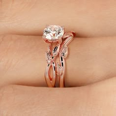 a woman's hand holding a rose gold ring with a diamond in the center