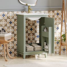 a bathroom with a green cabinet next to a sink