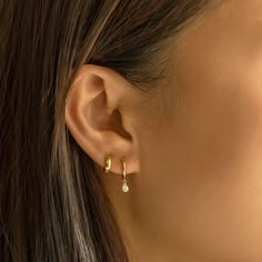 These 14K Gold Small Hoop earrings feature a tiny dangling Pear Crystal with prong setting. It offers just the right amount of sparkle for your big day. 14K Gold Moissanite Crystals Hypoallergenic, lead and nickel free Height 0.6in (16mm) Hoop: Inside Diameter 8.2mm, Thickness 1.8mm Pear 5mm x 3mm Click Snap closure #ES056-G Gold Hoop Double Piercing, Tiny Double Hoop Earrings, Earrings 2 Holes Silver, Second Ear Piercing Loop, Gold Ear Stacking, Gold Hoop Earrings 2 Piercings, Double Gold Earrings, Gold Double Piercing Stud, Hoop In Second Piercing