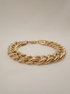 Define your rebellious style with The Benjamin Chain Bracelet! This bold accessory is designed for those who dare to push boundaries, featuring a unique blend of edginess and trailblazing charm. Nail your look every time with this unisex gold chain bracelet. This cool bracelet features bold diamond cut chain links and is the perfect women's or men's gold chain link bracelet that packs a punch! Complete your look by stacking it with these chain bracelets: - The Kennedy Chain Bracelet - The Elliot Bold Metal Bracelets For Gift, Trendy Cuban Link Gold Chain Bracelet, Trendy Gold Chain Cuban Link Bracelet, Trendy Gold Chain Bracelet With Cuban Link, Trendy Cuban Link Bracelet With Chunky Chain, Trendy Metal Cuban Link Bracelet With Chunky Chain, Trendy Everyday Curb Chain Bracelets, Trendy Cuban Link Chunky Chain Bracelets, Trendy Link Bracelet With Curb Chain