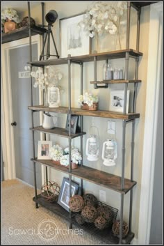 a shelf with pictures and flowers on it