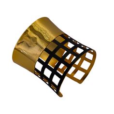 In this design, we've crafted a striking wide-cuffed bracelet adorned with geometric cubes to exude simplicity, style, and harmony. The bracelet features a prominent cuff design with geometric embellishments, creating a captivating dual-tone aesthetic for a seamless look. Crafted with brass as the primary metal, it's plated with 24-karat pure gold and coated with black rhodium for both durability and luxurious appeal. Here are the detailed specifications: Material: Brass main metal plated with 24-karat pure gold Design: Wide cuff adorned with geometric cubes Flexibility: Flexible for comfortable wear Measurements: Bracelet width: 2.76 inches Bracelet length: 6.42 inches This description highlights the intricate craftsmanship and use of premium materials, elevating any outfit with a touch o Modern Adjustable Evening Bracelets, Adjustable Luxury Cuff Bracelet For Parties, Luxury Adjustable Cuff Bracelet For Party, Luxury Jubilee Cuff Bracelet As Gift, Luxury Adjustable Jubilee Cuff Bracelet, Luxury Jubilee Cuff Bracelet Gift, Modern Evening Cuff Bracelet Bangle, Modern Evening Cuff Bangle Bracelet, Modern Evening Cuff Bracelet