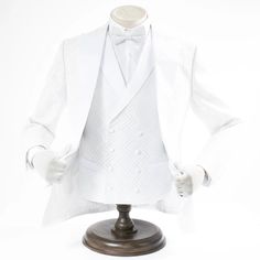 a mannequin dressed in a white tuxedo and bow tie