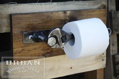 a toilet paper dispenser attached to a wooden shelf with wood slats