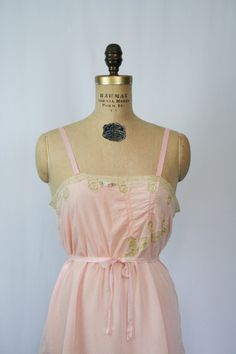 Pink Lace Trim Slip Dress For Daywear, Vintage Pink Slip Dress With Lace Trim, Flirty Lace Trim Slip Dress For Daywear, Delicate Sleeveless Slip Dress For Daywear, Pink Lace Camisole In Coquette Style, Coquette Lace Trim Slip Dress For Daywear, Pink Lace Coquette Camisole, Pink Spaghetti Strap Camisole For Daywear, Vintage Lace Trim Slip Dress