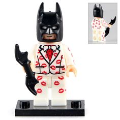 the lego batman movie minifigure is wearing a suit and holding a bat