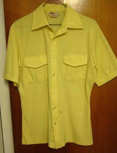 MONTGOMERY WARD vtg small beat-up button-down shirt rockabilly mod pockets hip This is a previously-owned, adult-small (S), yellow, short-sleeved button-down shirt. It measures approximately 19 inches (from underarm seam to underarm seam) and is in fair condition, as there are a few small marks on the front near the very bottom (Montgomery Ward brand, 100% polyester). It will need professionally laundered or dry-cleaned for maximum satisfaction… Montgomery Ward (later known as Wards or Monkey Wa Fitted Summer Camp Shirt With Pockets, Fitted Camp Shirt With Pockets For Summer, Fitted Cotton Camp Shirt With Button Closure, Retro Yellow Cotton Camp Shirt, Retro Cotton Shirt With Pockets, Retro Fitted Camp Shirt For Spring, Yellow Retro Cotton Camp Shirt, Retro Short Sleeve Tops With Pockets, Classic Fitted Collared Camp Shirt