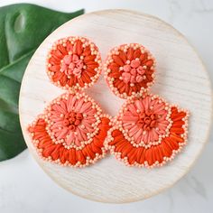 Add a pop of color to your style with these Coral Raffia Flower Drops. These earrings are lightweight, making them comfortable to wear all day. Perfect for adding a touch of fun and vibrancy to any outfit. Made with high-quality materials for durability and style. Lead and Nickel free. Bohemian Flower Earrings For Summer, Bohemian Summer Flower Earrings, Summer Style Earrings For Beach In Spring, Multicolor Beaded Earrings For Summer Vacation, Bohemian Beach Earrings With Handmade Flowers, Pink Beaded Earrings For Beach, Bohemian Earrings With Handmade Flowers For Beach, Pink Beaded Earrings For The Beach, Coral Earrings For Summer Beach Occasion