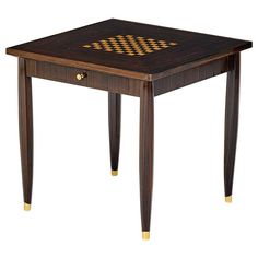 a wooden table with an interesting design on the top and gold trim around the edges