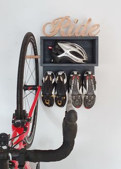 there is a bike and some shoes hanging on the wall next to a bicycle rack