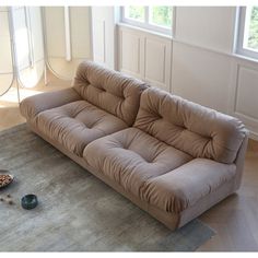 a couch sitting on top of a rug in a living room