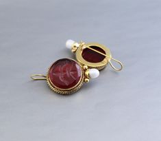 Description Gemstone - Red Glass Material - Brass Gemstone Size - 18 mm Earring Height Including Hoop - 4 cm Earring Width - 2 cm Finish - Smooth and high polished with brilliant shine. Note -The earrings are made to order, production day is about 3-5 working days. The one you receive may be slight different from the one in the picture due to handmade nature, but it will be almost same as in the above picture.These pieces are handcrafted from start to finish and have an imperfect handmade look.These earrings are the perfect addition to your collection. Our rings are meant to be classic enough for everyday wear or to give as a bridesmaid gift. You will receive the same piece as in the picture or identical. Since all gemstones are different from each other, I cannot guarantee that the gemsto Red Cabochon Earrings For Wedding, Red Pendant Earrings For Wedding, Red Gemstone Pendant Earrings, Red Cabochon Earrings Perfect For Gifts, Red Cabochon Earrings For Gift, Red Round Clip-on Earrings, Silver Jewlery, Bracelet Quotes, Edwardian Jewelry