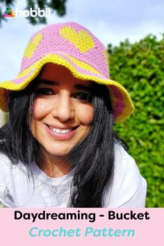 a woman wearing a pink and yellow hat with the words daydreaming - bucket yarn design pattern