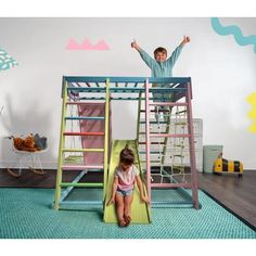 two children are playing on the slide in their room