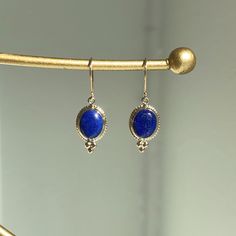 14KT Yellow Gold Oval Blue Lapis Gemstone Earring Charms with Detailed Frame on Shepard Hook Length: 29 including bail Width: 10mm Flat backside  1 pair Approx 2 grams Stamped 14K Charming oval, blue lapis charms w/ yellow gold bail + detailing! Pendant also available  Please let us know if you have any questions. Thank you, Legacy Saint Jewelry Elegant Blue Oval Cabochon Earrings, Blue Oval Earrings With Natural Stones, Blue Lapis Lazuli Oval Jewelry, Elegant Lapis Lazuli Earrings With Natural Stones, Blue Oval Cabochon Gemstone Jewelry, Classic Royal Blue Oval Jewelry, Blue Oval Cabochon Jewelry With Gemstone Accents, Oval Sapphire Jewelry With Gemstone Accents, Elegant Sapphire Earrings With Natural Stones