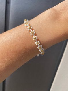 White Daisy Flower Bracelet | Beaded Bracelet | Daisy Flower Bracelet | Daisy with Gold Details Daisy Flower Jewelry, Delicate White Flower Bracelets, Delicate White Flower Beaded Bracelets, Delicate White Flower Shaped Beaded Bracelets, White Dainty Flower Shaped Beaded Bracelets, Delicate White Flower Pearl Bracelet, White Beaded Bracelets With Flower Charm For Spring, Spring White Beaded Bracelets With Flower Charm, Delicate White Bracelets For Spring