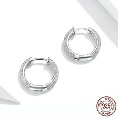 These stunning sterling silver cubic zircon hoop earrings are a beautiful addition to a ladies' outfit. Every piece is beautifully arranged and made with a 925 sterling silver high polished finish covered with zircon stones and comes packed in a Cycolinks gift bag. ✔️ FREE Worldwide shipping, we ship to over 250 Countries! ✔️ 925 sterling silver, platinum-plated, 3 layer electroplating to last! ✔️ Weight - 1.6g pair ✔️ Connection type: Simple ear clip ✔️ The materials are 925 sterling silver env Silver Cubic Zirconia Small Hoop Earrings, Small Hoop Silver Cubic Zirconia Earrings, Small Hoop Sterling Silver Earrings In Diamond White, Cubic Zirconia Round Hoop Earrings, Small Hoop Earrings In White Gold With Cubic Zirconia, White Gold Small Hoop Earrings Cubic Zirconia, Silver Sterling Silver Hoop Diamond Earrings, Cubic Zirconia Fine Jewelry Hoop Earrings, Cubic Zirconia Hoop Earrings Fine Jewelry