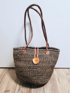 These brown sisal bags, also known as Kiondo bags, are handwoven from sisal, the strongest natural fiber, by the Kamba women in Kenya. All the materials used in designing the bags are locally sourced in Kenya. Its sisal design make the bags eco-friendly and leather trimmings guarantee durability. It can be used as an everyday sling or shoulder bag as it is stylish.  Key features: Handwoven exterior (from sisal) and inner cotton lining Adjustable leather strap Zip closure and extra leather strap Sisal Bags, African Bag, Handwoven Bag, Summer Bag, Pocket Book, Woven Bag, Bag Bag, Colourful Outfits, Beach Bag