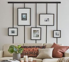 a living room filled with lots of furniture and pictures on the wall above it's coffee table