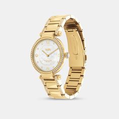 Timeless and elegant the Cary watch is a sophisticated style perfect for day or night. The gold tone bracelet design shimmers with crystals and features a luminous mother-of-pearl dial with our iconic Horse and Carriage motif for a heritage touch. | Coach Cary Watch, 34 Mm - Women's - Gold Elegant Gold-tone Watch With Round Dial, Classic Gold Coach Watch, Classic Gold-tone Watch With Round Dial, Luxury Coach Watches With Diamond Hour Markers, Coach Timeless Gold Watch, Gold Coach Watch With Metal Dial, Coach Gold Watches With Metal Dial, Coach Gold Watch With Metal Dial, Elegant Gold Coach Watch