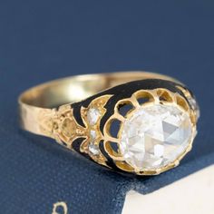 One of the most beautiful rose cut rings we have the pleasure of owning and offering up for sale. An original Vctorian-era jewel (the bottom shank has been replaced at some point in the past). The central rose cut diamond is that oft-requested yet seldom found these days - a true antique rose cut with that high dome and kaleidoscope-like face up. Incredibly white-facing. Set elegantly with prongs and enhanced with black enamel, the ring is regal in all its charm. We can only imagine what the nex Victorian Oval Diamond Ring With Rose Cut Diamonds, Victorian Rose Cut Diamond Ceremonial Rings, Victorian Ceremonial Ring With Rose Cut Diamonds, Victorian Style Diamond Ring With Diamond Cut, Victorian Style Diamond White Rose Cut Diamond Ring, Antique Single Diamond Jewelry In Diamond White, Heirloom Oval Rose Cut Diamond Jewelry, Victorian Jewelry With Single Diamond, Classic Rose Cut Diamond Rings For Ceremonial Occasions