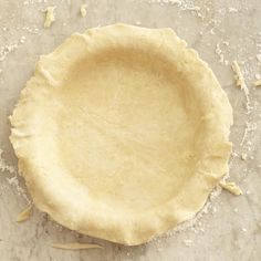 an uncooked pie crust sitting on top of a table