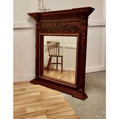 a chair is sitting in front of a mirror that has been placed on the floor