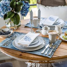 the table is set with blue and white dishes