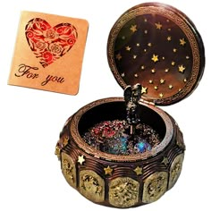 a small box with some sort of jewelry in it next to a playing card that says for you