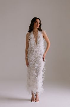 a woman wearing a white feather dress