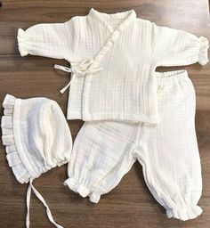 a white outfit and hat on a wooden floor