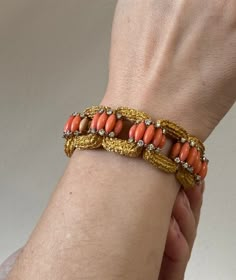 Exquisite 18k gold vintage 1960s bracelet, set with coral and approx. 3.00ctw VS-SI1/H diamonds. DESIGNER: Not Signed MATERIAL: 18k Gold GEMSTONES: Diamond, Coral DIMENSIONS: Bracelet is 6.75" long and 22mm wide. MARKED/TESTED: 18k, E65. WEIGHT: 86.2 grams CONDITION: Previously Owned/Excellent Condition Coral Gold Bangles, Orange Bracelet For Formal Occasions, Vintage Coral Jewelry For Wedding, Elegant Handmade Coral Bracelet, Formal Orange Bracelet Jewelry, Luxury Coral Jewelry For Formal Occasions, Coral Vintage Jewelry For Wedding, Formal Orange Bracelet, Retro Orange Jewelry For Formal Occasions