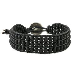 Siriporn of Thailand designs a handcrafted wristband bracelet showcasing the power and sophistication of black. Three rows of matte black glass beads are wrapped to black leather cords knotted at the ends. The bracelet fastens with a silver button stamped with a flower from the Karen hill tribe of Thailand. The bracelet has two loops for securing the silver button for an adjustable fit. Wristband Bracelet, Silver Button, Silver Buttons, Black Glass, Black Beads, Glass Bead, Leather Cord, A Flower, Wrap Bracelet