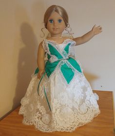 A magical, one of a kind ballgown for 18 inch dolls. This outfit comes in two pieces: 1.) The Dress: A gorgeous off white satin dress with organza and lace overskirts and a bodice made of crushed green satin petals/leaves trimmed with lace and pearls. Features handmade 3D chiffon flowers along the lower edge of the skirt. Has hook-and-loop tape in the back for ease of closure. 2.) The Veil: An off-white organza veil trimmed with handmade 3D chiffon flowers and gothic lace. Secures to doll's hair via bobby pin (included). Lace Princess Dress Ball Gown For Dress-up, White Lace Ball Gown With Lace Trim, Lace Bodice Ball Gown Pageant Dress, Lace Ball Gown Pageant Dress With Lace Bodice, Princess Style Lace Pageant Dress For Wedding, Princess Lace Pageant Dress For Wedding, White Lace Princess Dress For Debutante Ball, White Lace Pageant Dress With Lace Bodice, Debutante Ball Princess Dress With Lace Bodice